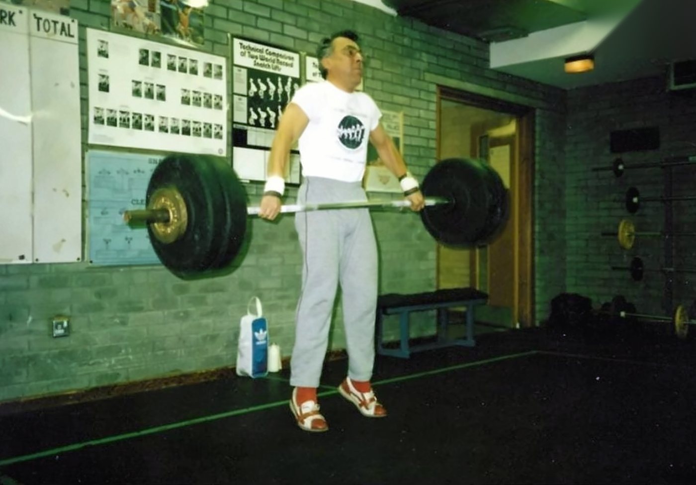 Brian pulling a loaded barbell in the club gym in the 1980s